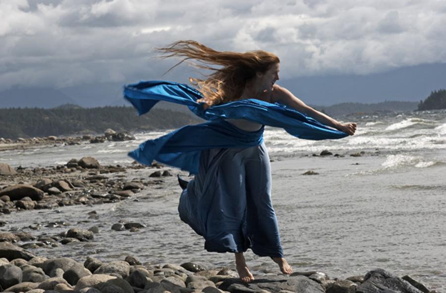 Woman doing yoga by the ocean | Hollyhock