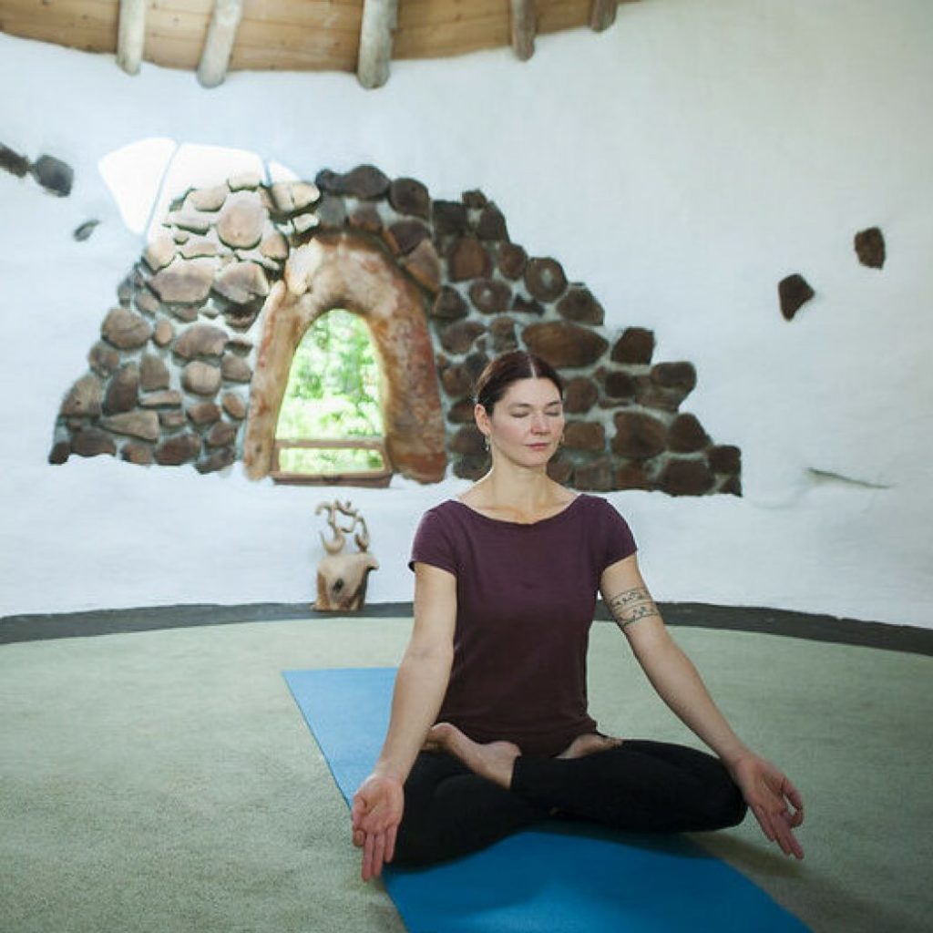 Woman doing yoga at the Hollyhock campus | Hollyhock