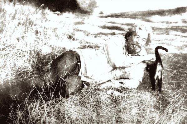 Richard Weaver, Founder of the Cold Mountain Institute, laying on the floor and petting a cat