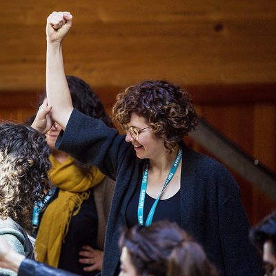 Woman raising her fist during a leadership program at Hollyhock Retreat Centre