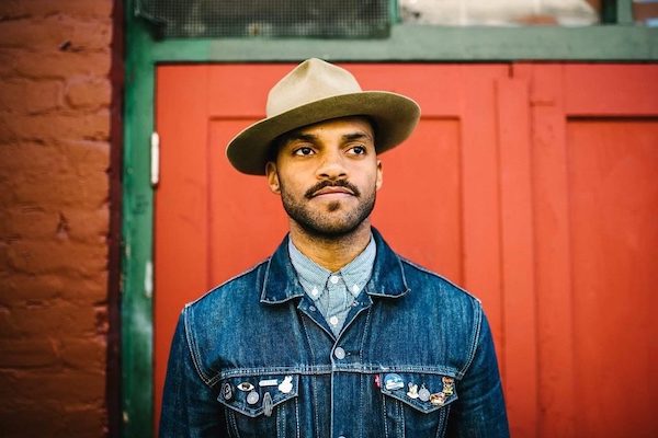 Hollyhock´s presenter, Khari Wendall McClelland, wearing a hat and a jeans jacket
